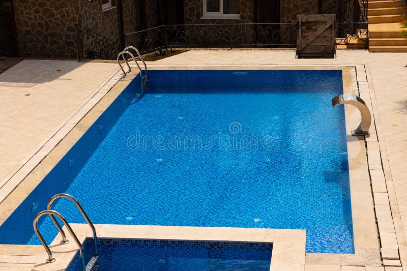 Pool with Blue Water Ladder for Descent and Ascent into the Water. the