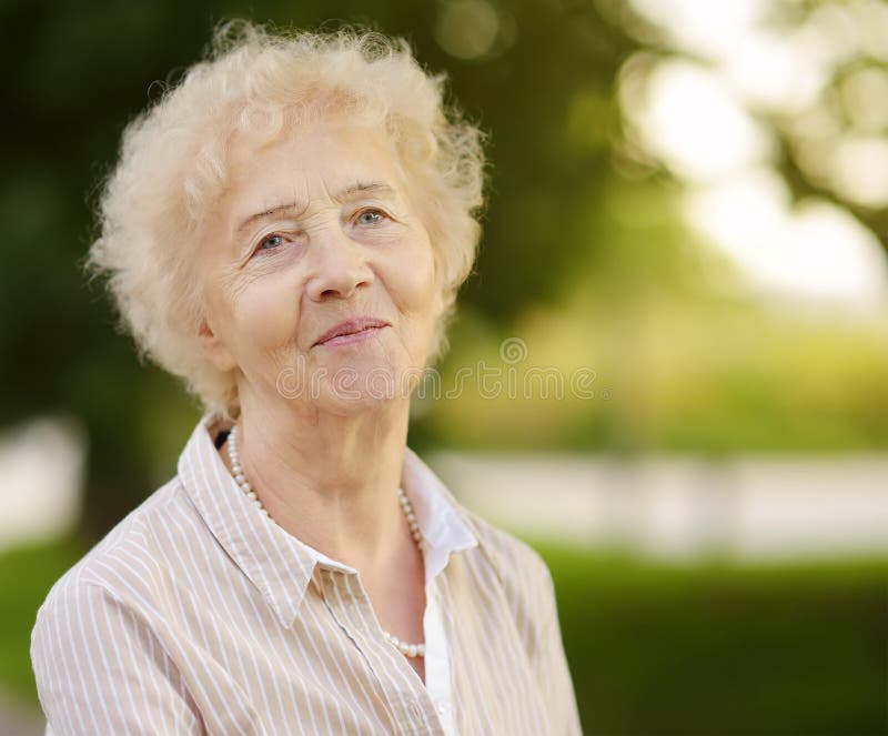 Outdoor portrait of beautiful senior woman with curly white hair stock images Outdoor portrait of beautiful senior woman with curly white hair stock images