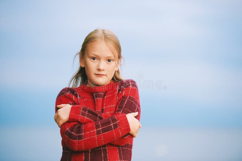 Summer portrait of 8-9 year old little girl wearing grey dress and purple flip  flops Stock Photo