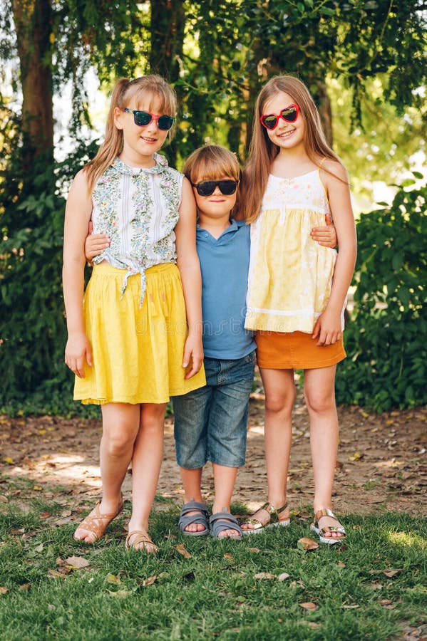 Outdoor portrait of 3 funny kids