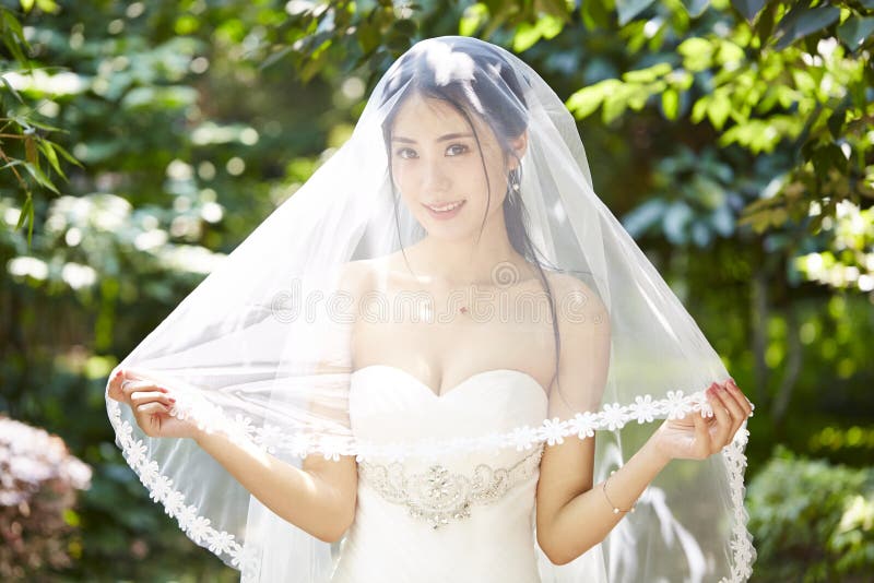 Outdoor Portrait of Happy Asian Bride ...