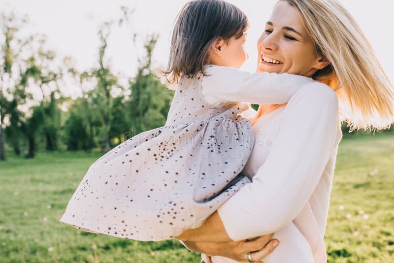 Outdoor Portrait Of Happy Beautiful Young Mother Dancing And Spinning With Her Daughter In The 