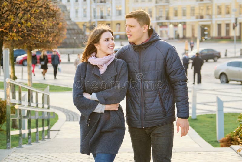 Outdoor portrait of happy embracing couple, handsome man and woman walking, background evening city royalty free stock image Outdoor portrait of happy embracing couple, handsome man and woman walking, background evening city royalty free stock image