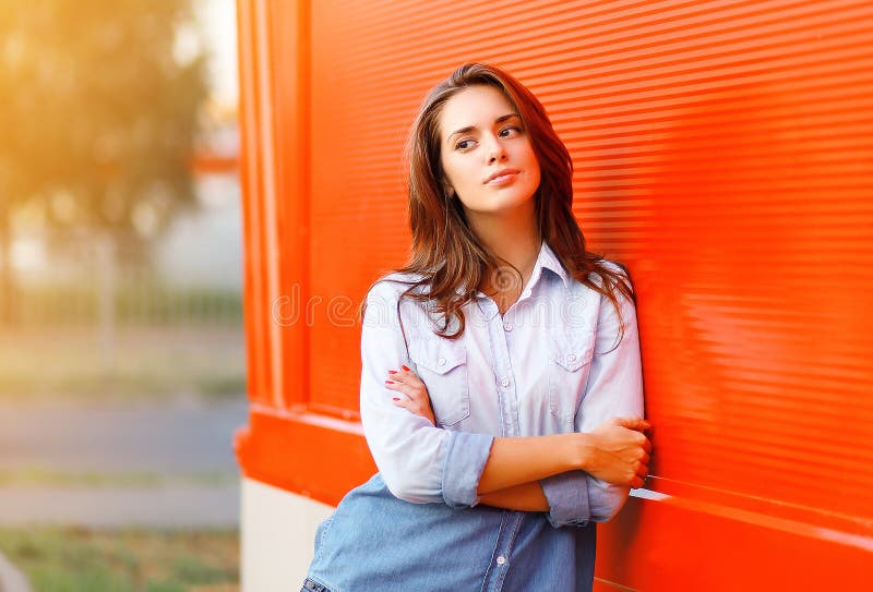 Outdoor portrait pretty woman against colorful wall