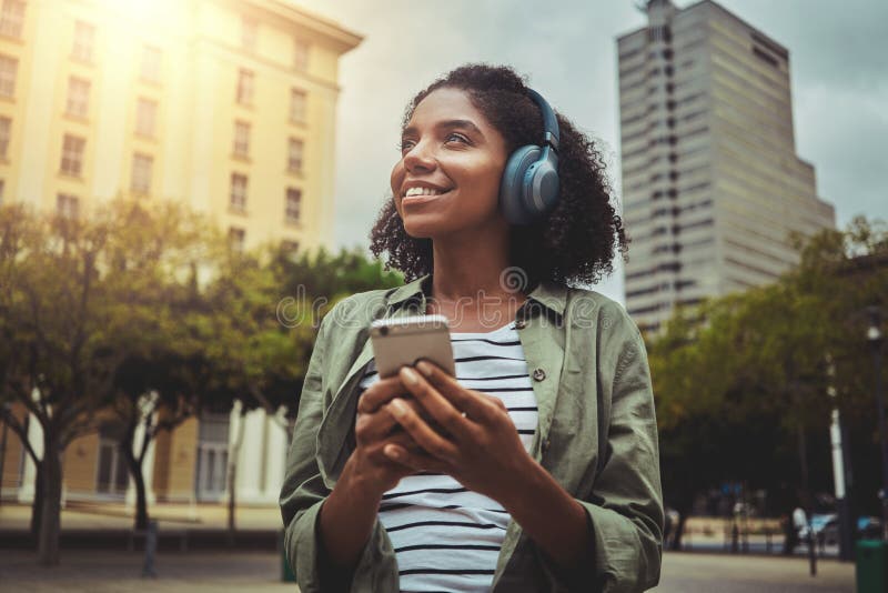 Outdoor portrait of woman listening to music using mobile phone stock image Outdoor portrait of woman listening to music using mobile phone stock image