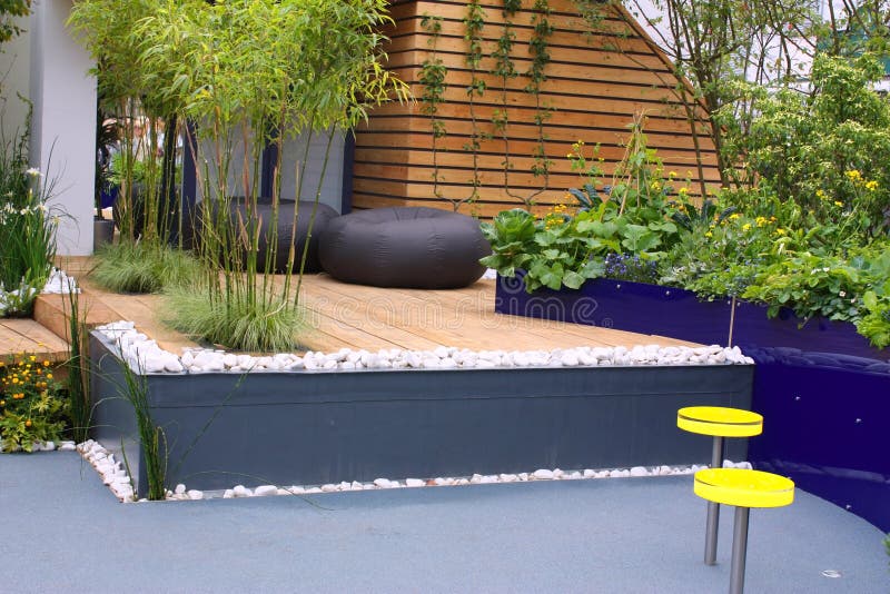 Outdoor Seating Area with Lounge Chairs and Parasols, Providing Shade in the Hot Sun Stock