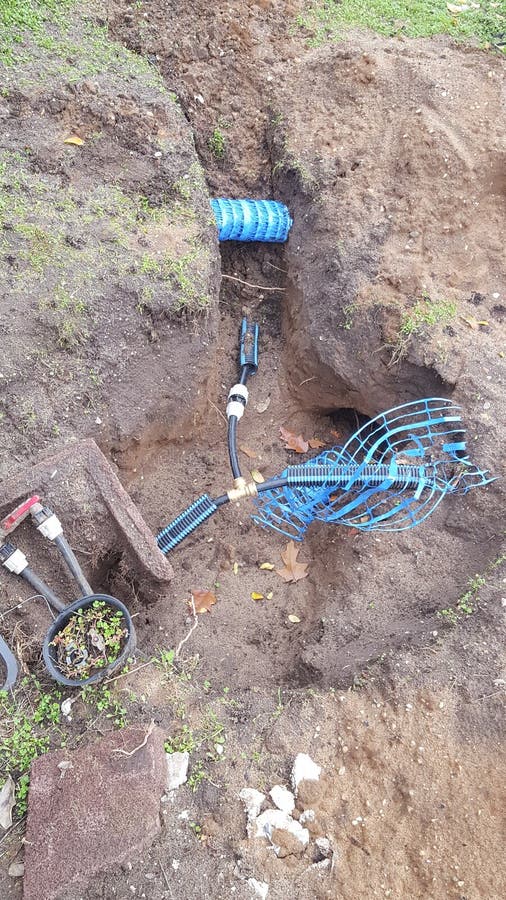 Trench Sliced into the Ground To Pass Running Water Pipes Stock Photo