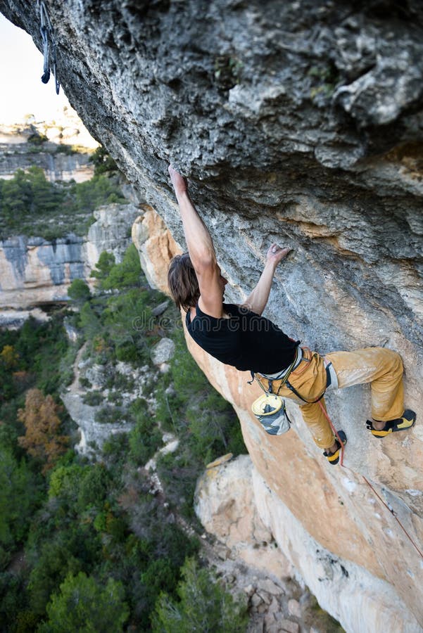 Outdoor Sport Rock Climber Ascending A Challenging Cliff Extreme