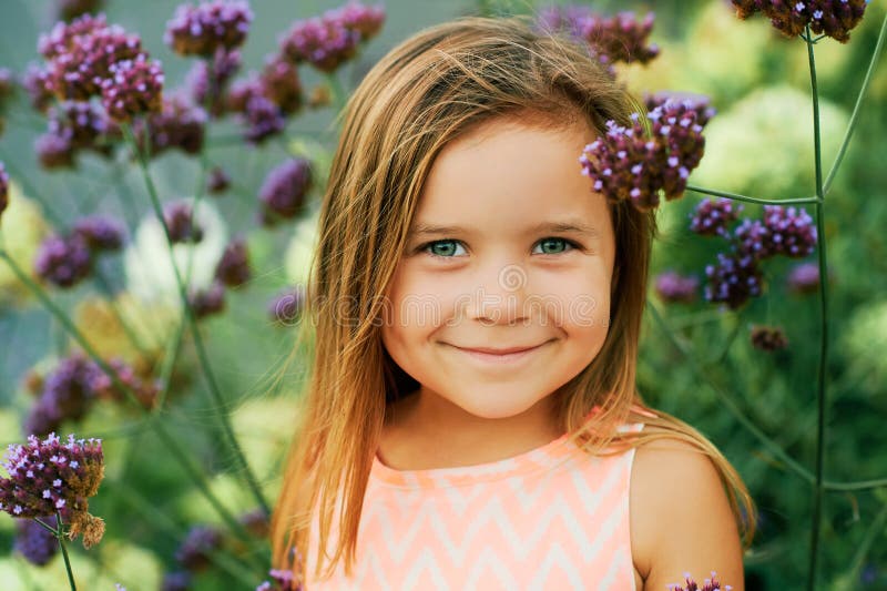 Outdoor summer portrait of adorable little girl of 3 or 4 years old