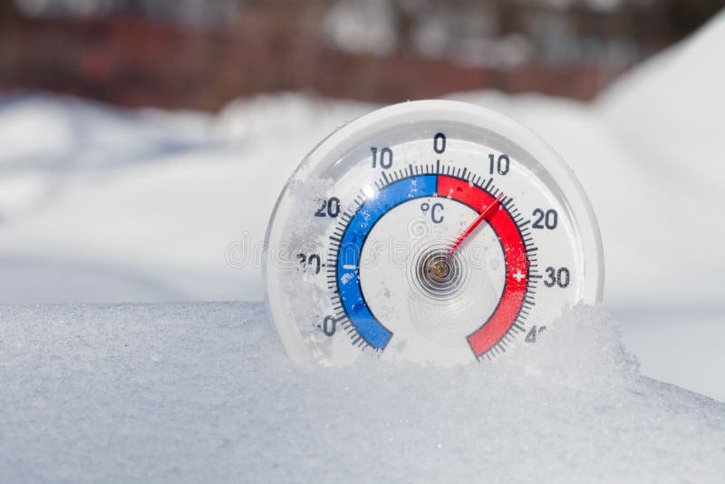Outdoor thermometer in snow shows warm temperature spring weathe. Thermometer with celsius scale in melting snow showing plus 13 degree temperature warm spring stock photography Outdoor thermometer in snow shows warm temperature spring weathe. Thermometer with celsius scale in melting snow showing plus 13 degree temperature warm spring stock photography