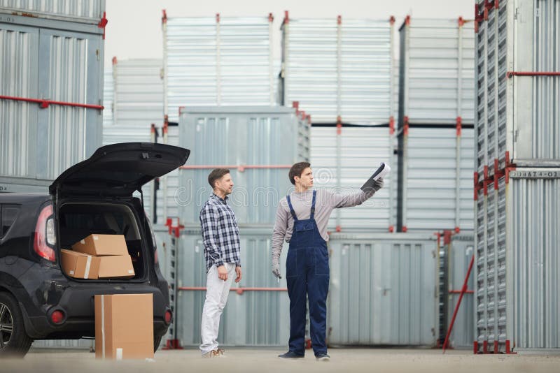 Outdoor warehouse manager explaining route to buyer stock photo Outdoor warehouse manager explaining route to buyer stock photo