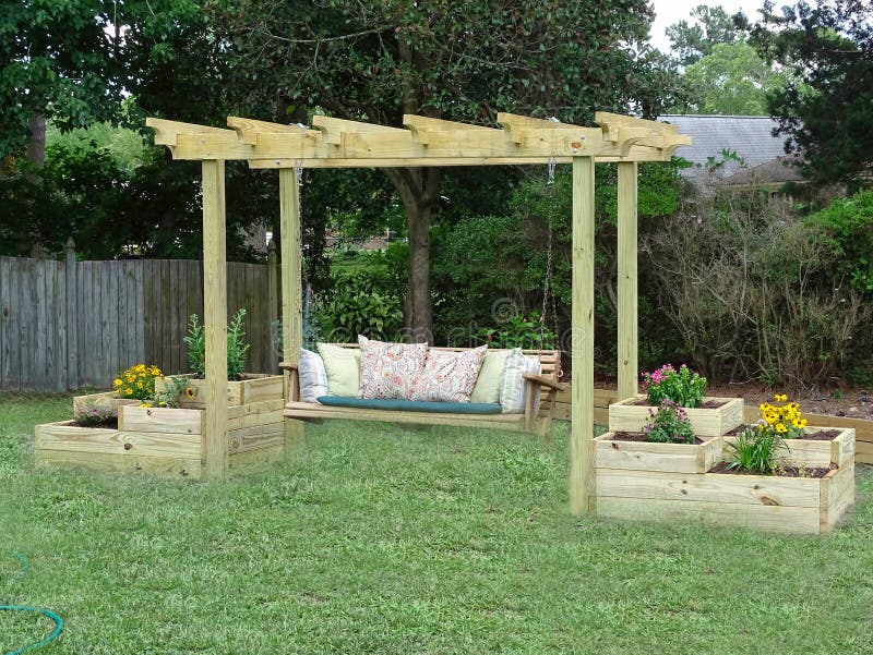 Outdoor wooden swing hanging from a trellis. Outdoor back yard swing with flower boxes
