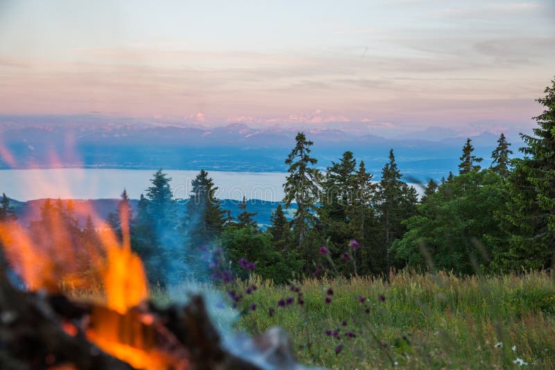 Outdoors Fire with Stone Hearth with Alps and Mont-Blanc Mountains in the Background royalty free stock photos Outdoors Fire with Stone Hearth with Alps and Mont-Blanc Mountains in the Background royalty free stock photos