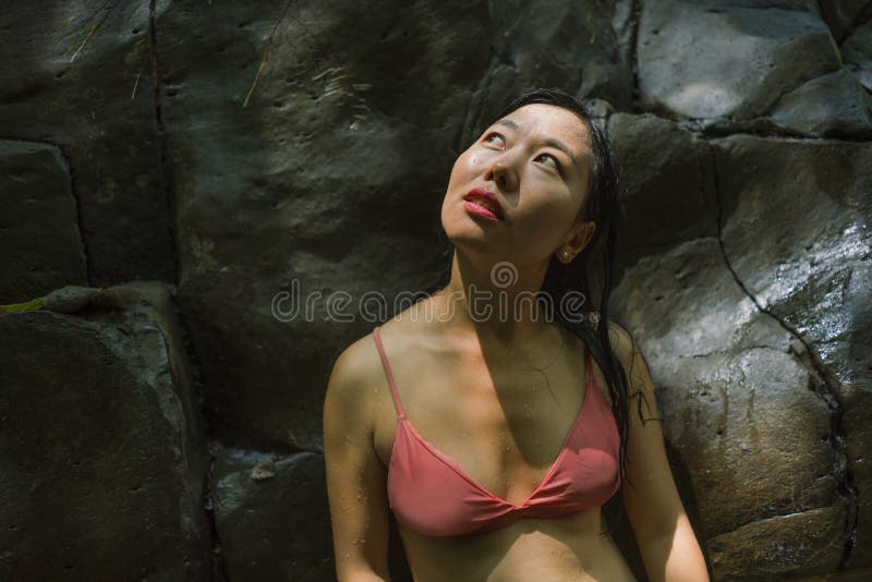 Outdoors lifestyle portrait of young beautiful and happy Asian Chinese woman in bikini enjoying Summer holidays at tropical forest royalty free stock photos Outdoors lifestyle portrait of young beautiful and happy Asian Chinese woman in bikini enjoying Summer holidays at tropical forest royalty free stock photos