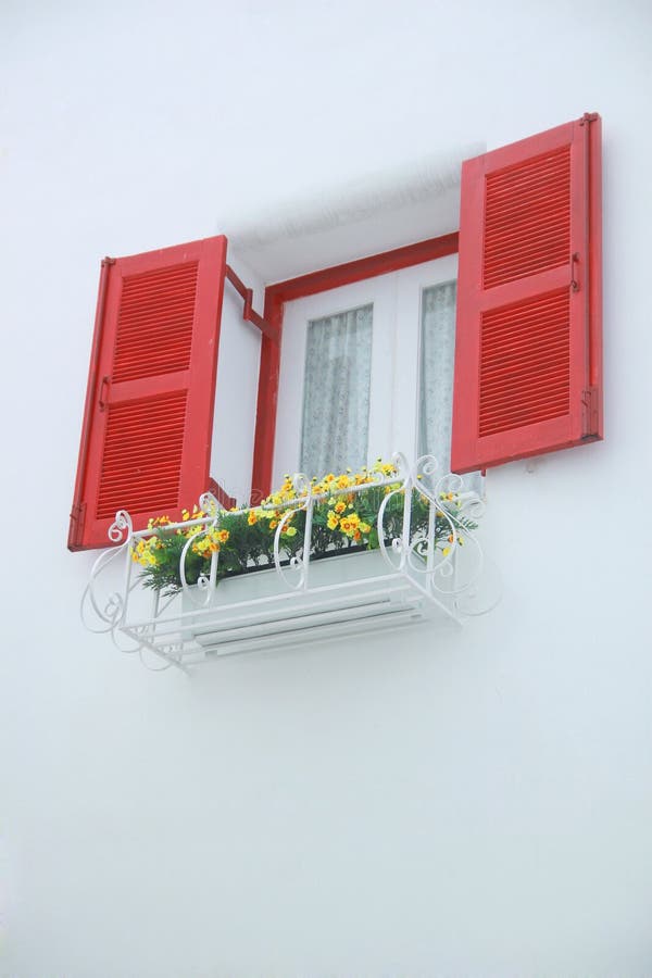 Outer opened red and white inner closed window with white wall decorated with flowerpod stock image Outer opened red and white inner closed window with white wall decorated with flowerpod stock image