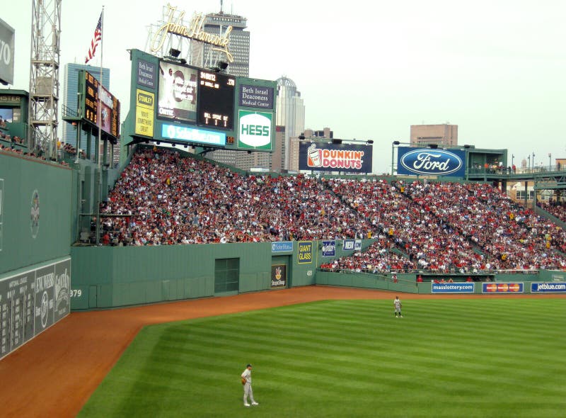 Outfielders stand in front of Green Monster Fenway royalty free stock image