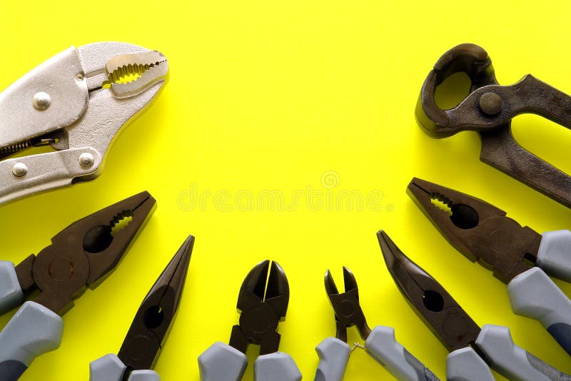 Assorted pliers tools collection display including cutter, breaker, grozier, needle-nose, pincer, locking, lineman on bright safety yellow background. Assorted pliers tools collection display including cutter, breaker, grozier, needle-nose, pincer, locking, lineman on bright safety yellow background