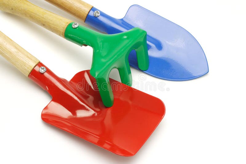 Close up of toy gardening tools on white background. Close up of toy gardening tools on white background