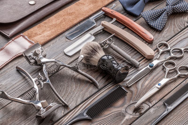 Vintage barber shop tools on old wooden background. Vintage barber shop tools on old wooden background