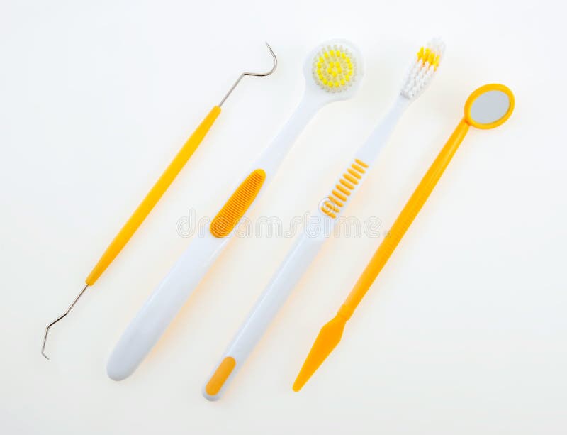 A set of yellow and white dental care tools. A set of yellow and white dental care tools.