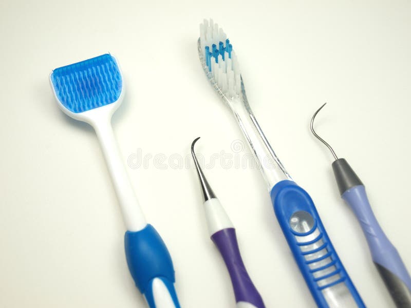 Common tools used for home dental care over a white background. Common tools used for home dental care over a white background.