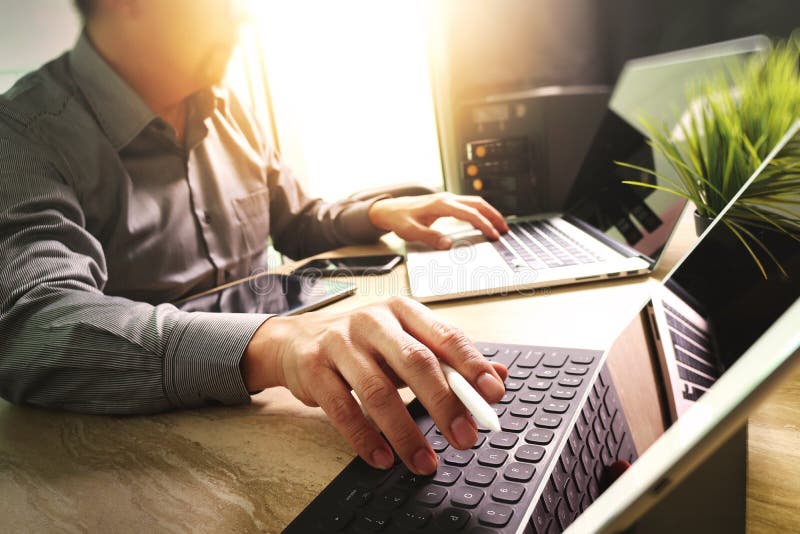 Outsource Developer working on marble Desk Working Laptop Computer Mobile Application Software and digital tablet dock smart stock images