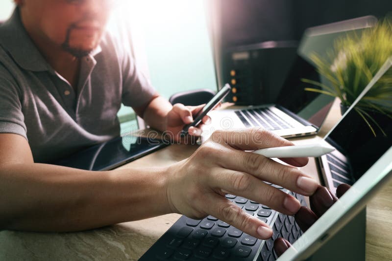 Outsource Developer working on marble Desk Working Laptop Computer Mobile Application Software and digital tablet dock smart stock photos