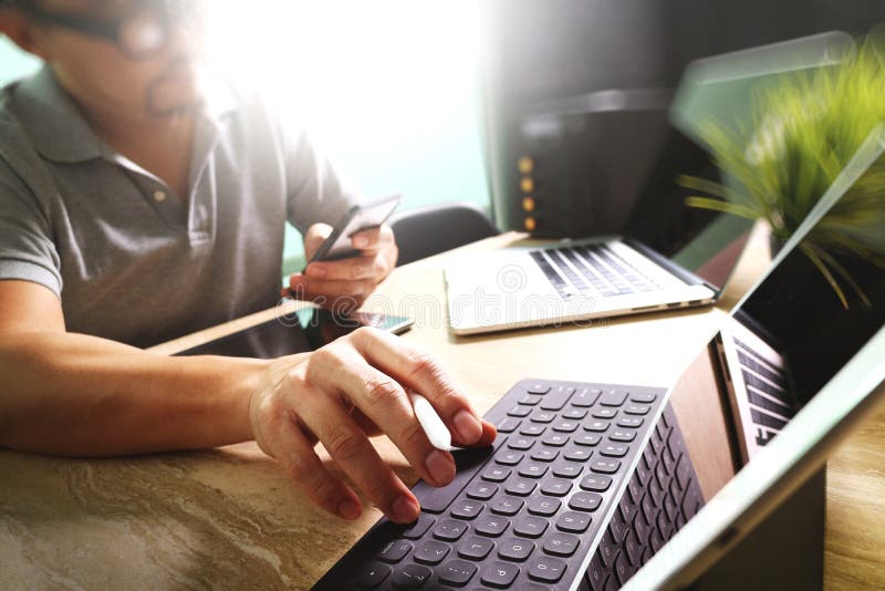 Outsource Developer working on marble Desk Working Laptop Computer Mobile Application Software and digital tablet dock smart royalty free stock images