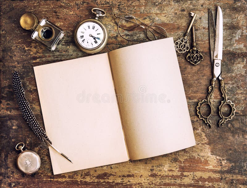 Open diary book and antique writing tools on wooden background. Vintage style toned picture. Open diary book and antique writing tools on wooden background. Vintage style toned picture