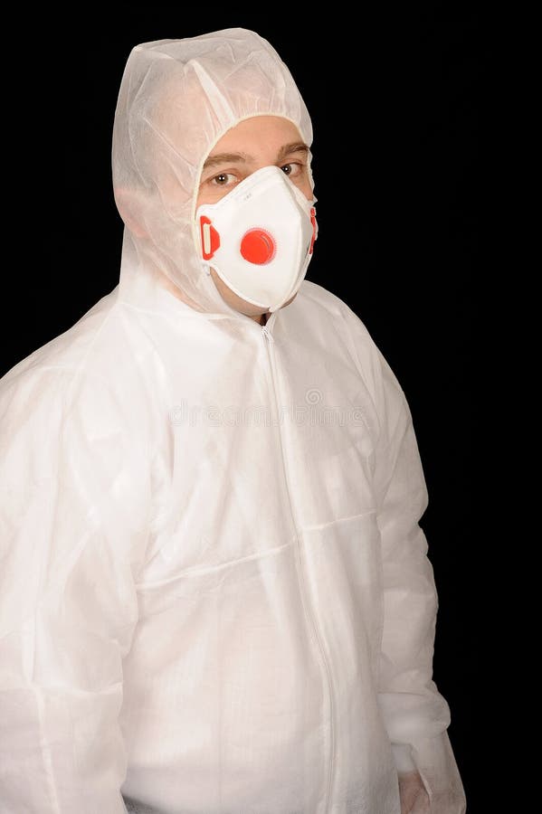 A portrait of a worker wearing a protective suit, on a black studio background. A portrait of a worker wearing a protective suit, on a black studio background.