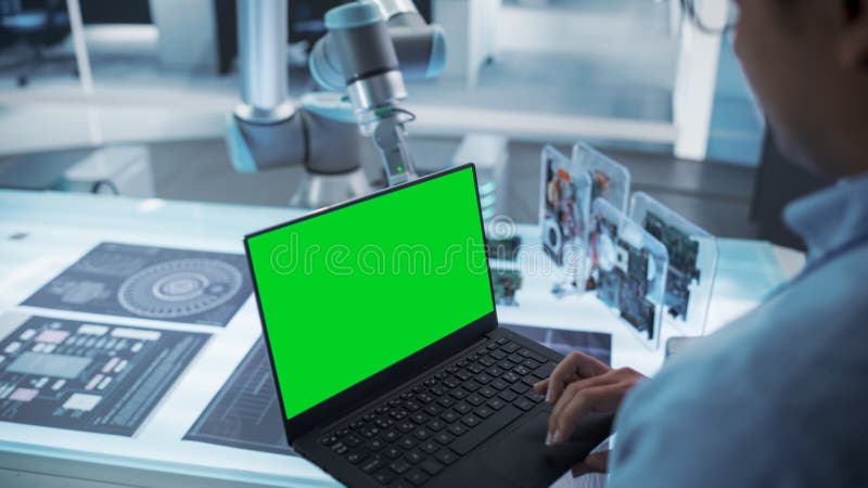 Over the Shoulder Shot of a Robotics Engineer Using a Laptop Computer ...
