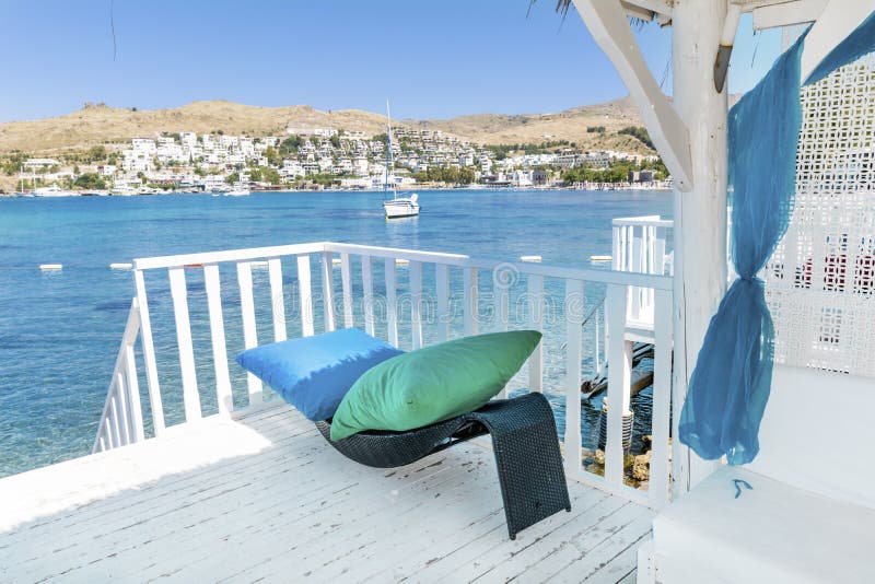Over water wooden bungalow with rattan sunbed and pillows royalty free stock images Over water wooden bungalow with rattan sunbed and pillows royalty free stock images
