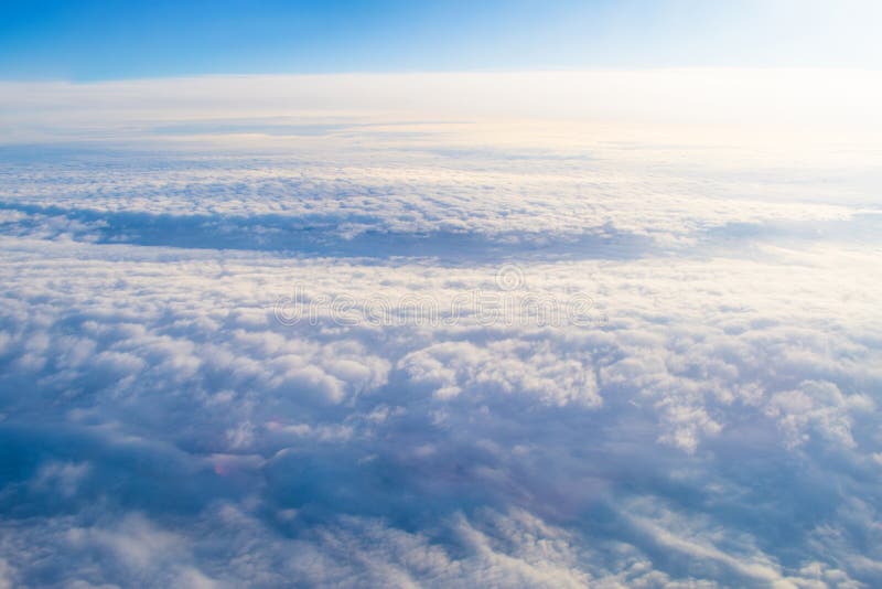 Overcast cloud cloudscape with height flight level of the airplane, smooth uniform texture of white steam before of the sunset. Airplane height stock images, royalty-free photos and pictures