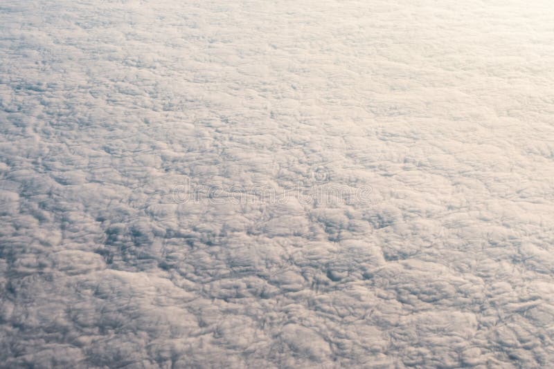 Overcast cloud with height flight level of the airplane, smooth uniform texture of white steam before of the sunset. Airplane height stock images, royalty-free photos and pictures