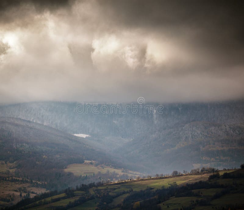 Overcast scene in cloudy mountains. Autumn rain