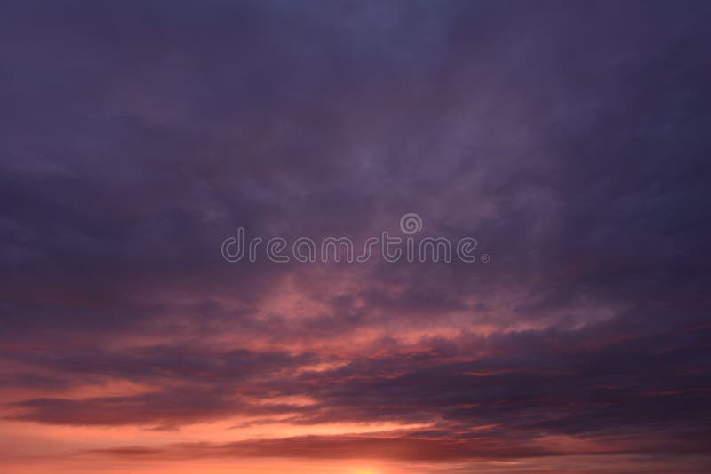 Overcast sky in thunderclouds in the fiery lava of sunlight at sunset royalty free stock photo Overcast sky in thunderclouds in the fiery lava of sunlight at sunset royalty free stock photo