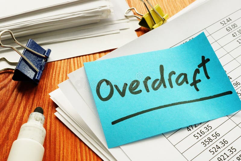 Overdraft sign and stack of accounting documents