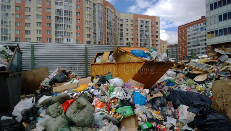 Overflowing trash in the background of a high-rise buildings royalty free stock image