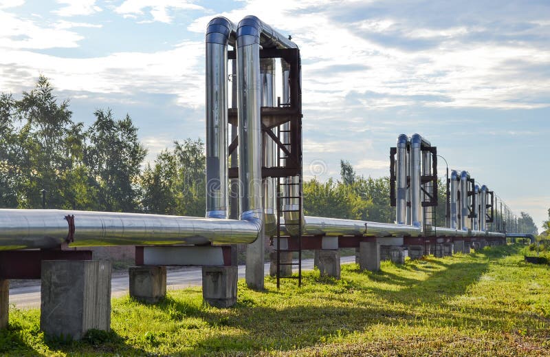 Overground heat pipes. Pipeline above the earth conducting heat for heating city stock photos Overground heat pipes. Pipeline above the earth conducting heat for heating city stock photos