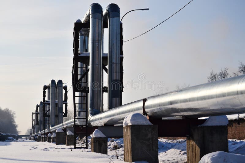 Overground heat pipes. Pipeline above ground, conducting heat for heating the city. Winter. Snow royalty free stock photos Overground heat pipes. Pipeline above ground, conducting heat for heating the city. Winter. Snow royalty free stock photos