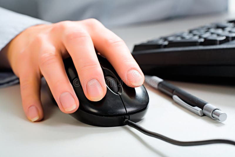 Close-up of female hand touching a computer mouse. Close-up of female hand touching a computer mouse