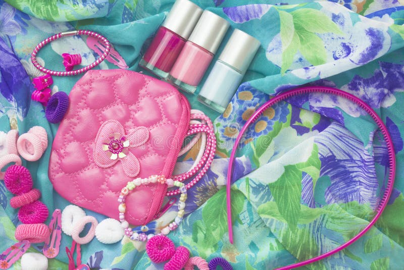 An overhead photo of little girl accessories, lifestyle set. Headband and nail polish. A group of girlish teenager accessories and stock images An overhead photo of little girl accessories, lifestyle set. Headband and nail polish. A group of girlish teenager accessories and stock images
