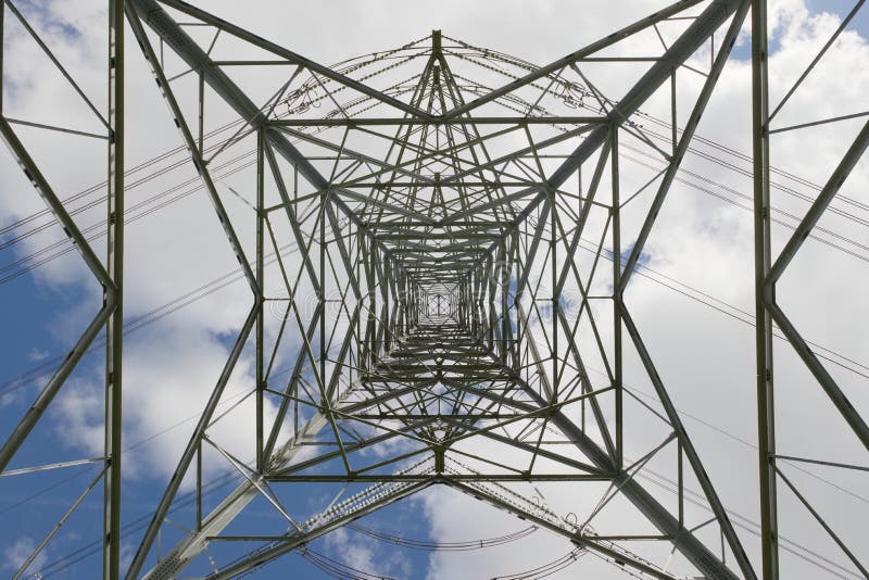 Overhead power lines turn on a tall pylon, part of the national grid stock photos
