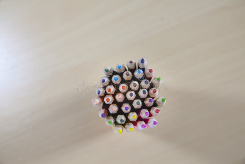 Overhead shot of a bundle of colored pencils on a wooden surface stock photo