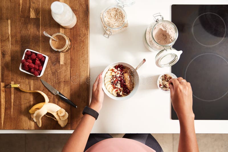 Overhead Shot Of Woman Preparing Healthy Breakfast At Home After Exercise