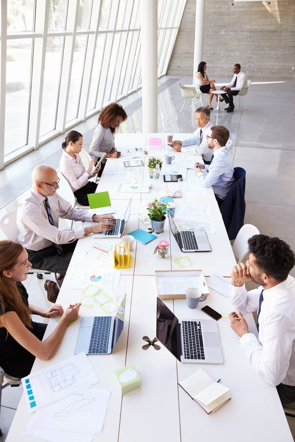 Overhead View of Business Meeting Around Boardroom Table Stock Image