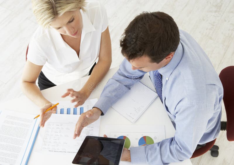 Overhead View Of Businesswoman And Businessman Working At Desk Together royalty free stock photos Overhead View Of Businesswoman And Businessman Working At Desk Together royalty free stock photos