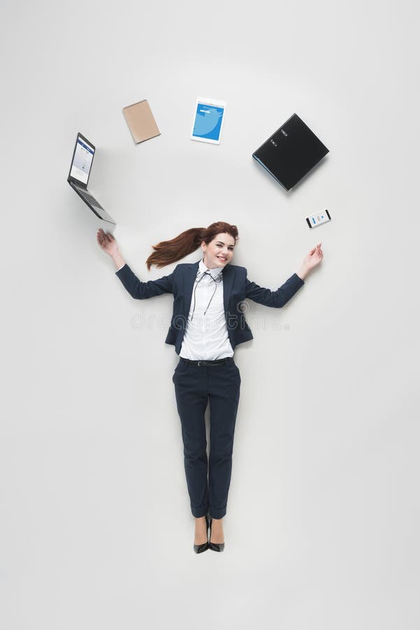 overhead view of businesswoman with various office supplies using laptop stock photography overhead view of businesswoman with various office supplies using laptop stock photography