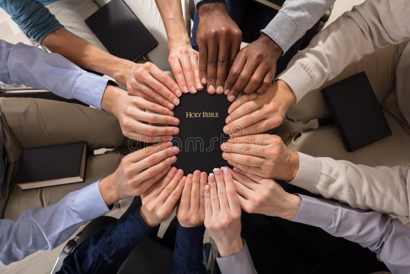 Hands Holding Holy Bible stock photography