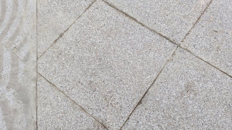 An overhead view of large paving stones with a rough aggregate texture and visible grout lines, arranged in a royalty free stock photos